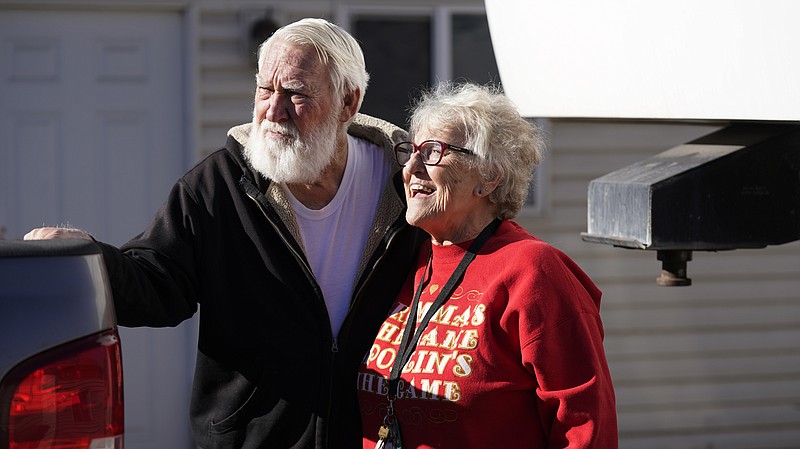 Kathy and Bud Scott pose for a photograph at their home Thursday, Dec. 3, 2020, in West Valley, Utah. Many snowbirds who live part time in warmer climates to escape cold weather won't be flocking south this winter. (AP Photo/Rick Bowmer)