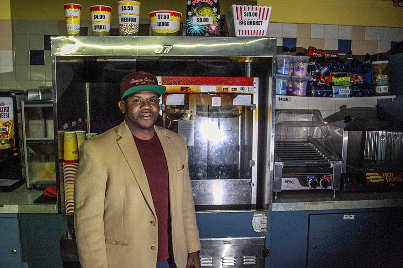 Steven Mays Jr., who, with his business partner, Okori Ezieme, owns Saracen 8 Cinema at the Pines Mall, stands in the darkened concession area of the theater, which has been closed since March 15 of this year, initially due to the coronavirus shutdown but subsequently due to a legal dispute with mall owner Judy Vu and her family. (Pine Bluff Commercial/Dale Ellis)