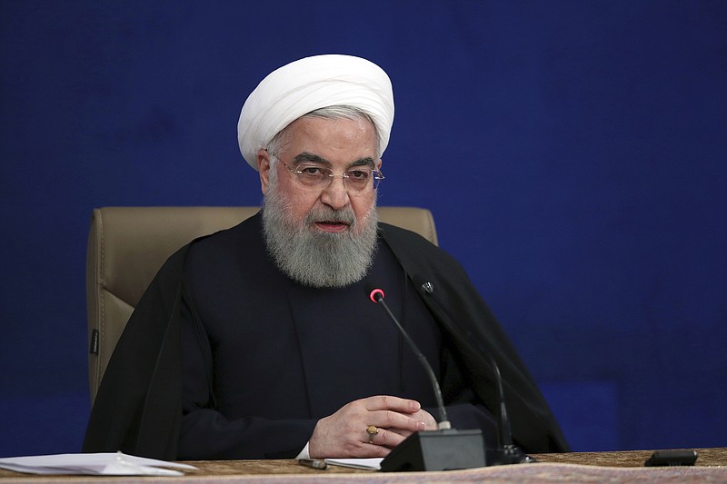 In this photo released by the official website of the office of the Iranian Presidency, President Hassan Rouhani speaks during his press conference in Tehran, Iran, Monday, Dec. 14, 2020. Rouhani on Monday claimed that Israel was behind the killing of a scientist who founded the Islamic Republic’s military nuclear program in the 2000s in an effort to start a war in the last days of President Trump's administration. (Iranian Presidency Office via AP)