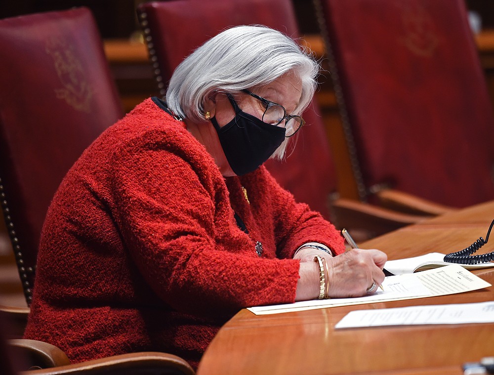 Connecticut Presidential Electoral Chair Susan Barrett signs her official certificate of vote Monday, Dec. 14, 2020, in the Senate Chamber of the State Capitol in Hartford, Conn. (Brad Horrigan/Hartford Courant via AP)