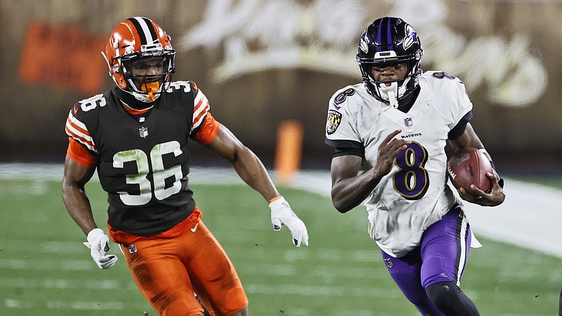 Baltimore Ravens quarterback Lamar Jackson (8) scrambles under pressure from Cleveland Browns cornerback M.J. Stewart Jr. (36) during the second half of an NFL football game, Monday, Dec. 14, 2020, in Cleveland. (AP Photo/Ron Schwane)