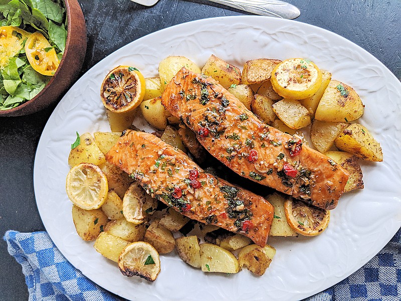 Salmon marinated in a spicy-sweet mix of brown sugar, soy sauce, ginger and chili is roasted along with potatoes for a quick and healthful dinner. (TNS/Pittsburgh Post-Gazette/Gretchen McKay)