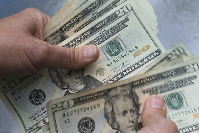 FILE - In this June 15, 2018, file photo, 20-dollar bills are counted in North Andover, Mass. (AP Photo/Elise Amendola, File)