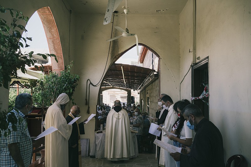 Worshippers gather outside a local Maronite church in the Karantina neighborhood in Beirut in August, days after its structure was heavily damaged in a massive port explosion.
(The Washington Post/Lorenzo Tugnoli)