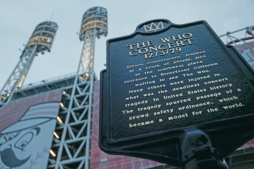 FILE - This Wednesday, Nov. 20, 2019, file photo shows a memorial plaque for the 11 concertgoers who were killed in a crush of people entering a 1979 concert by the British rock band The Who, outside Great American Ball Park in Cincinnati. Alumni of nearby Finneytown High School, who lost three classmates in the tragedy, faced obstacles in 2020 to their annual memorial scholarship fund-raising event. In the end, they created a show of prerecorded video interviews with The Who's frontman, Roger Daltrey, guitarist-songwriter Pete Townshend and a mix of recorded and live discussions with relatives of the 11 people killed in the tragedy. (AP Photo/John Minchillo, File)