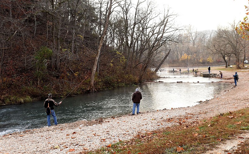 Anglers fish at Roaring River State Park on Nov. 13 during opening day of the park's catch and release trout season. Fishing is allowed with flies only Friday through Monday from 8 a.m. to 4 p.m. The season opens each year on the second Friday of November and closes at 4 p.m. on the second Monday in February. Anglers may catch an unlimited number of trout, but all must be released.
(NWA Demorcrat-Gazette/Flip Putthoff)
