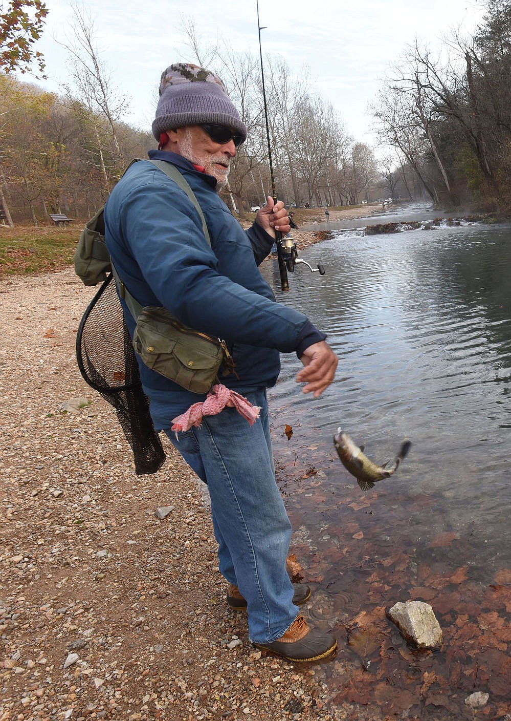 Ken Lawrence of Warsaw, Mo., lands one of the dozens of rainbow trout he caught Nov. 13 2020 at Roaring River State Park. Lawrence ties his own jigs. White or green are his favorite colors.
(NWA Democrat-Gazette/Flip Putthoff)