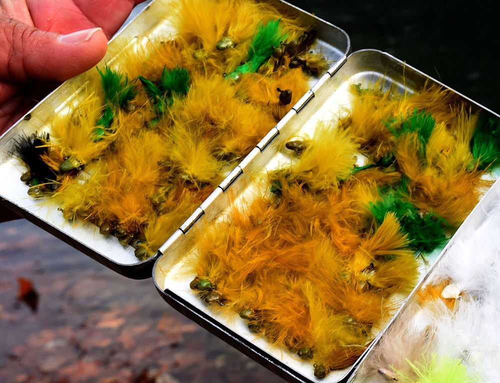 A peek into Ken Lawrence's fly box on Nov. 13 2020 reveals jigs he ties himself for fishing at Roaring River State Park. Lawrence caught and released more than 100 rainbow trout on opening day of catch and release season at the park. Green or white are his go-to colors.
(NWA Democrat-Gazette/Flip Putthoff)