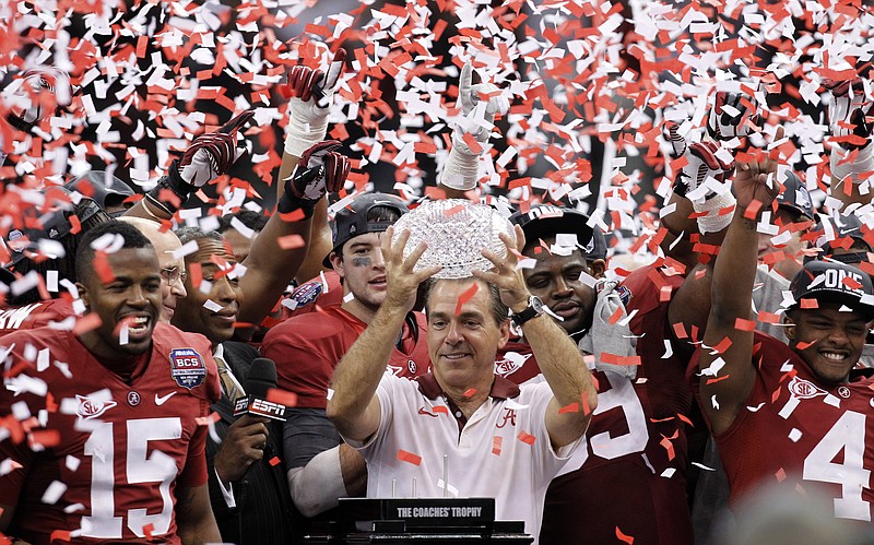 FILE - Alabama head coach Nick Saban celebrates with his team after the BCS National Championship college football game against LSU in New Orleans, in this Monday, Jan. 9, 2012, file photo, Alabama won 21-0. Saban's dominating run at Alabama is more than just wins and championships. He's also ruined the careers of many of his fellow SEC coaches and cost the league's other 13 schools more than $100 million in buyouts -- all in search of someone who can knock the game's greatest coach from his perch.(AP Photo/Gerald Herbert, File)