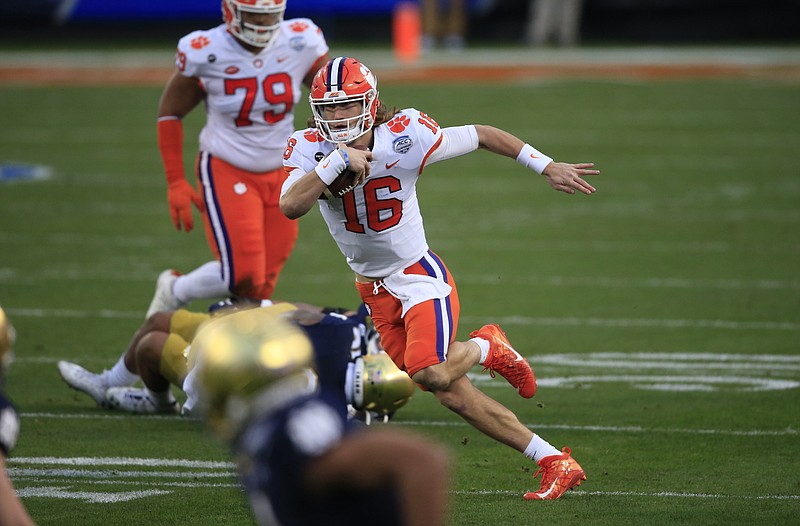 Clemson quarterback Trevor Lawrence (16) runs the ball during the first half of the Atlantic Coast Conference championship NCAA college football game against Notre Dame, Saturday, Dec. 19, 2020, in Charlotte, N.C. (AP Photo/Brian Blanco)