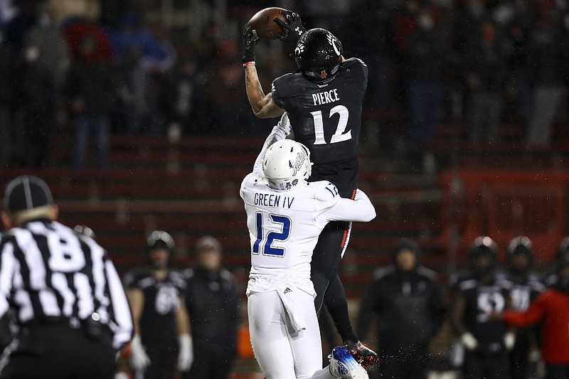 Tulsa cornerback Allie Green IV (12) defends as Cincinnati wide receiver Alec Pierce (12) catches a pass during the first half of the American Athletic Conference championship NCAA college football game, Saturday, Dec. 19, 2020, in Cincinnati. (AP Photo/Aaron Doster)