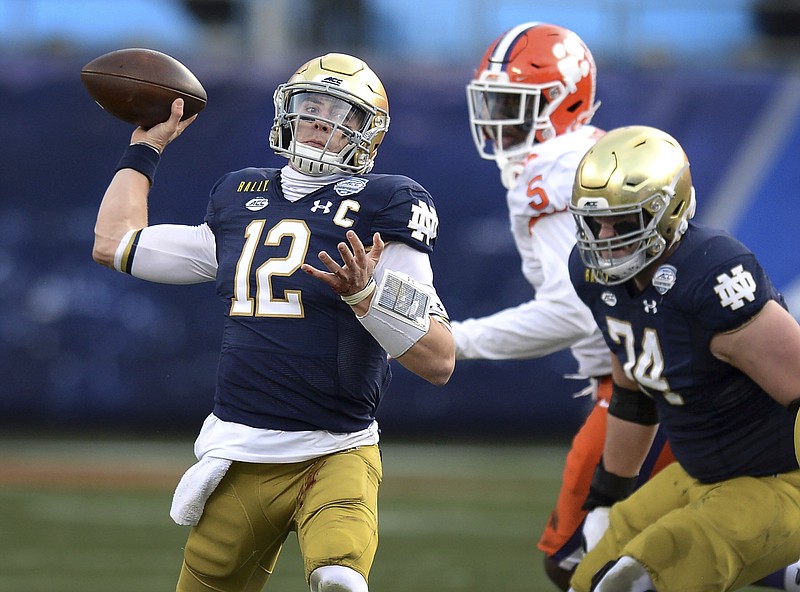 Notre Dame quarterback Ian Book throws a pass against Clemson during the Atlantic Coast Conference championship NCAA college football game, Saturday, Dec. 19, 2020, in Charlotte, N.C. (Jeff Siner/The News & Observer via AP)