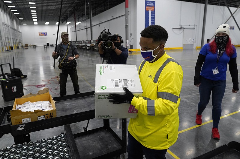 Boxes containing the Moderna COVID-19 vaccine are prepared to be shipped at the McKesson distribution center in Olive Branch, Miss., Sunday, Dec. 20, 2020. (AP Photo/Paul Sancya, Pool)