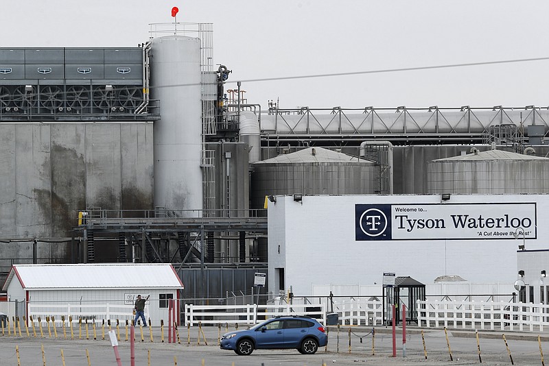 FILE—In this Friday, May 1, 2020, photo, a worker leaves the Tyson Foods plant in Waterloo, Iowa. The coronavirus devastated the nation's meatpacking communities in Iowa, Nebraska, and Minnesota earlier in the year. Behemoths like Walmart and Tyson, which have been the target of COVID-19-related lawsuits, can largely absorb any losses. But hundreds of negligence lawsuits have been filed across the country, with mom-and-pops most fearing the prospect of litigation that could put them under. (AP Photo/Charlie Neibergall, File)
