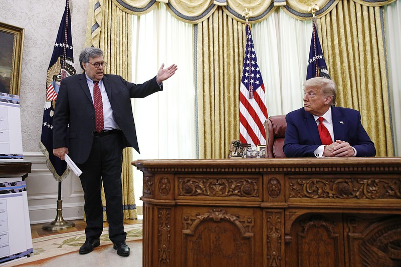 FILE - In this July 15, 2020, file photoAttorney General William Barr, left, speaks with President Donald Trump during a a law enforcement briefing on the MS-13 gang in the Oval Office of the White House in Washington. (AP Photo/Patrick Semansky, File)