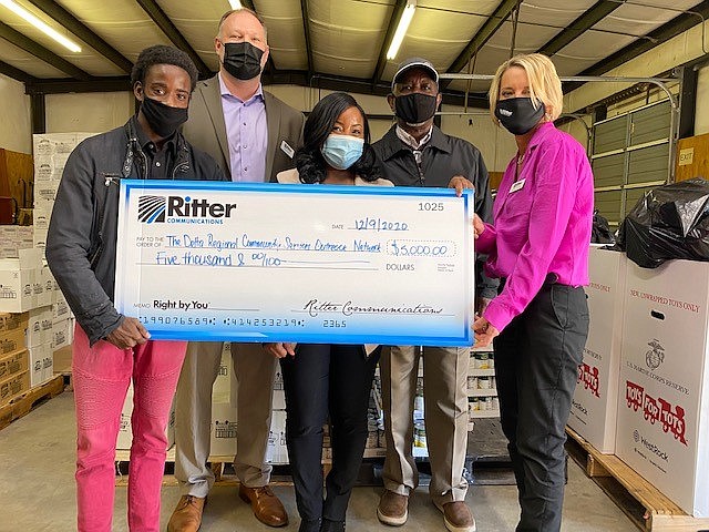 Delta Network Foodbank representatives accept a $5,000 donation from Ritter Director of Sales Josh Bradley, second from left, and sales representative Michele Watson, far right. (Special to The Commercial)