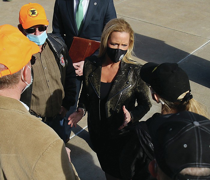 Attorney General Leslie Rutledge (right center) talks with National Rifle Association members on Tuesday, Dec. 22, 2020, on the steps of the state Capitol in Little Rock. Rutledge announced her office her office has filed an amicus brief in support of the NRA in a lawsuit by the state of New York to dissolve the NRA. 
(Arkansas Democrat-Gazette/Thomas Metthe)