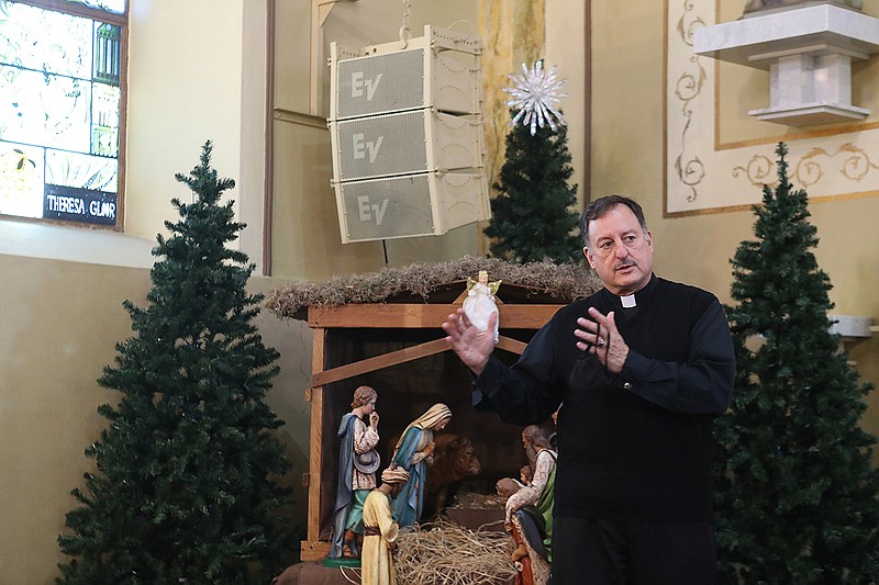 The Rev. George Sanders, pastor of St. John the Baptist Catholic Church of Hot Springs, discusses safety measures being taken by the church to ensure the safety of parishioners. - Photo by Richard Rasmussen of The Sentinel-Record