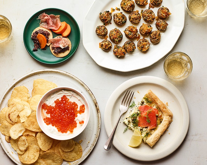 This menu of tasty party snacks — Fig-Olive Tapenade With Prosciutto and Persimmon; Crispy Stuffed Mushrooms With Harissa and Apricots; Smoked Salmon, Fennel and Herbed Mascarpone Tart; and Caviar Sour Cream Dip With Potato Chips — is perfect for the 2020 version of a holiday blowout — that is, all-night nibbling on the couch. (The New York Times/Andrew Purcell)