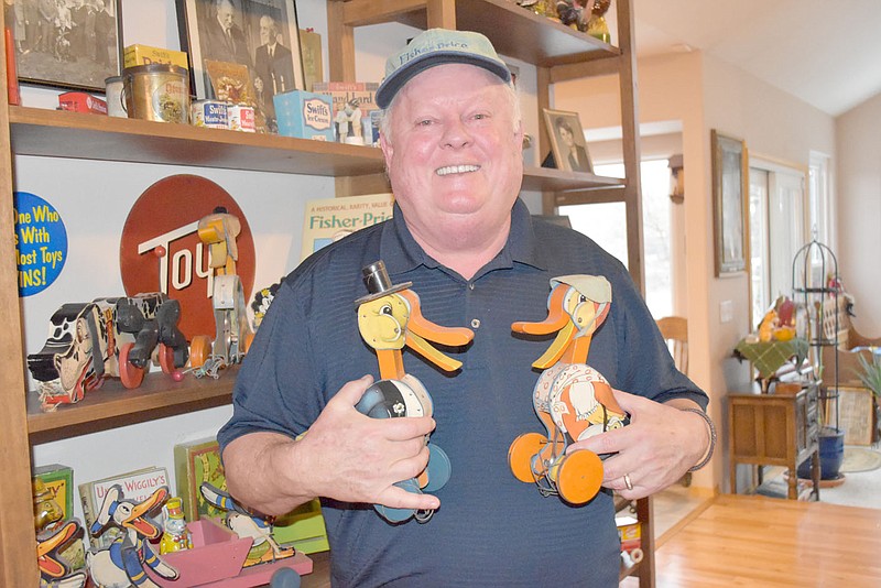 Rachel Dickerson/The Weekly Vista Bruce Fox, who worked 31 years for Fisher-Price and has a collection of 500 Fisher-Price toys, is pictured with Dr. Doodle, left, and Granny Doodle, the lead toys in the first year Fisher-Price toy line of 1931, which were called the 16 Hopefuls.