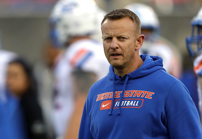 FILE - In this Saturday, Dec. 21, 2019 file photo, Boise State coach Bryan Harsin watches his players warm up for the Las Vegas Bowl NCAA college football game against Washington at Sam Boyd Stadium in Las Vegas. No. 25 San Jose State will face perennial conference powerhouse Boise State in the Mountain West championship on Saturday, Dec. 19, 2020 in Las Vegas. The game is usually played on the higher seed’s home field but this year it will be held at Sam Boyd Stadium.  (AP Photo/Steve Marcus, File)
