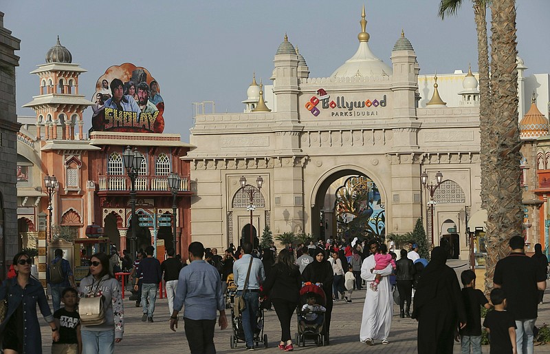 FILE - In this Dec. 18, 2016 file photo, people visit the Bollywood theme park at Dubai Parks & Resorts in Dubai, United Arab Emirates. The owner of Dubai's struggling theme park operator is planning to sell itself to its majority shareholder, the company said in documents filed Sunday, Dec. 20, 2020, with the Dubai Financial Market, capping years of plummeting income and stocks. (AP Photo/Kamran Jebreili, File)