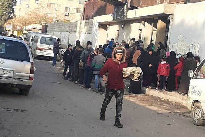 People wait in a line outside bakeries in Damascus, Syria, as a wheat crisis limits their daily access to bread. MUST CREDIT: photo obtained by The Washington Post.