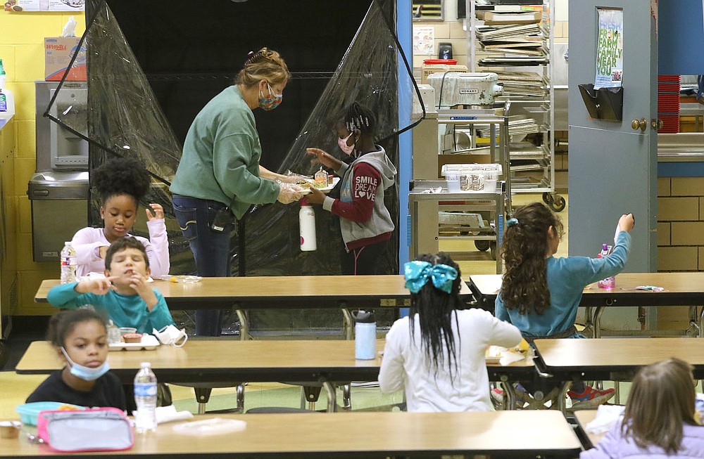 Paraprofessional Terri Lankford hands out lunches to second-grade students Dec. 11 at Gibbs Magnet Elementary School in Little Rock.
Check out nwaonline.com/201228Daily/ and nwadg.com/photos for a photo gallery.
(Arkansas Democrat-Gazette/Thomas Metthe)