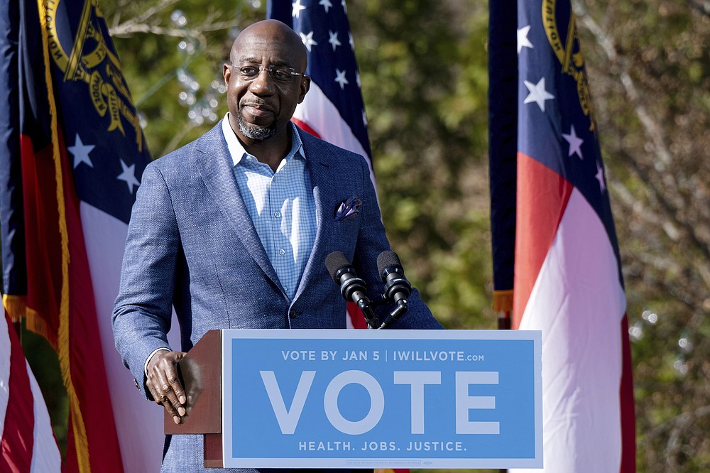 Democratic U.S. Senate challenger the Rev. Raphael Warnock speaks during a rally, Monday, Dec. 21, 2020 in Columbus, Ga. with Vice President-Elect Kamala Harris and fellow Democratic U.S. Senate challenger Jon Ossoff. (AP Photo/Ben Gray)