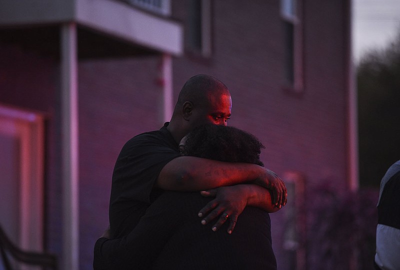 Mark Cooper (from left) hugs his wife Tara Cooper, Saturday, April 11, 2020 at the Robinson Park Apartments in Lowell. Check out nwaonline.com/200412Daily/ for today’s photo gallery.
(NWA Democrat-Gazette/Charlie Kaijo)

An apartment building at the Robinson Park Apartments caught fire on Saturday afternoon. After fire fighters distinguished the fire, family members discovered that three-year-old child Tanzley Wright who was staying in the apartment before the fire occurred went missing. Family members and neighbors searched the complex. A fire fighter discovered the child in the building and reunited her with the family.