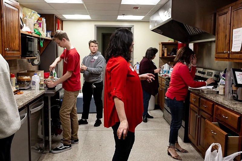 Volunteers prepare a meal for residents at the Northwest Arkansas Women’s Shelter in Rogers.

(Courtesy photo)