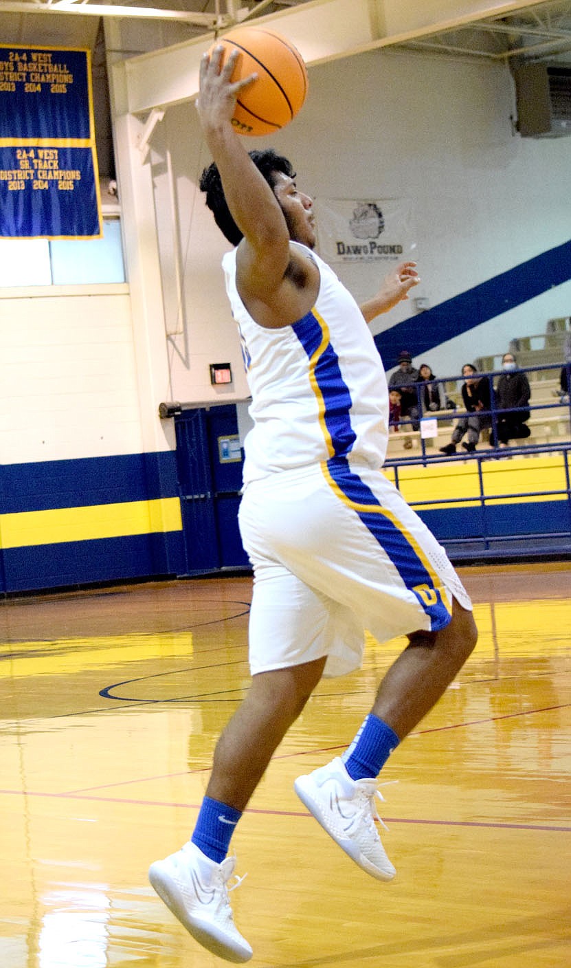 Westside Eagle Observer/MIKE ECKELS
Carlos Hernandez goes up high to catch a high pass during the final seconds of the third quarter of the Decatur-Ozark Catholic Academy basketball game in Decatur Thursday afternoon. Hernandez passed the ball back to a teammate as time ran out in the quarter.
