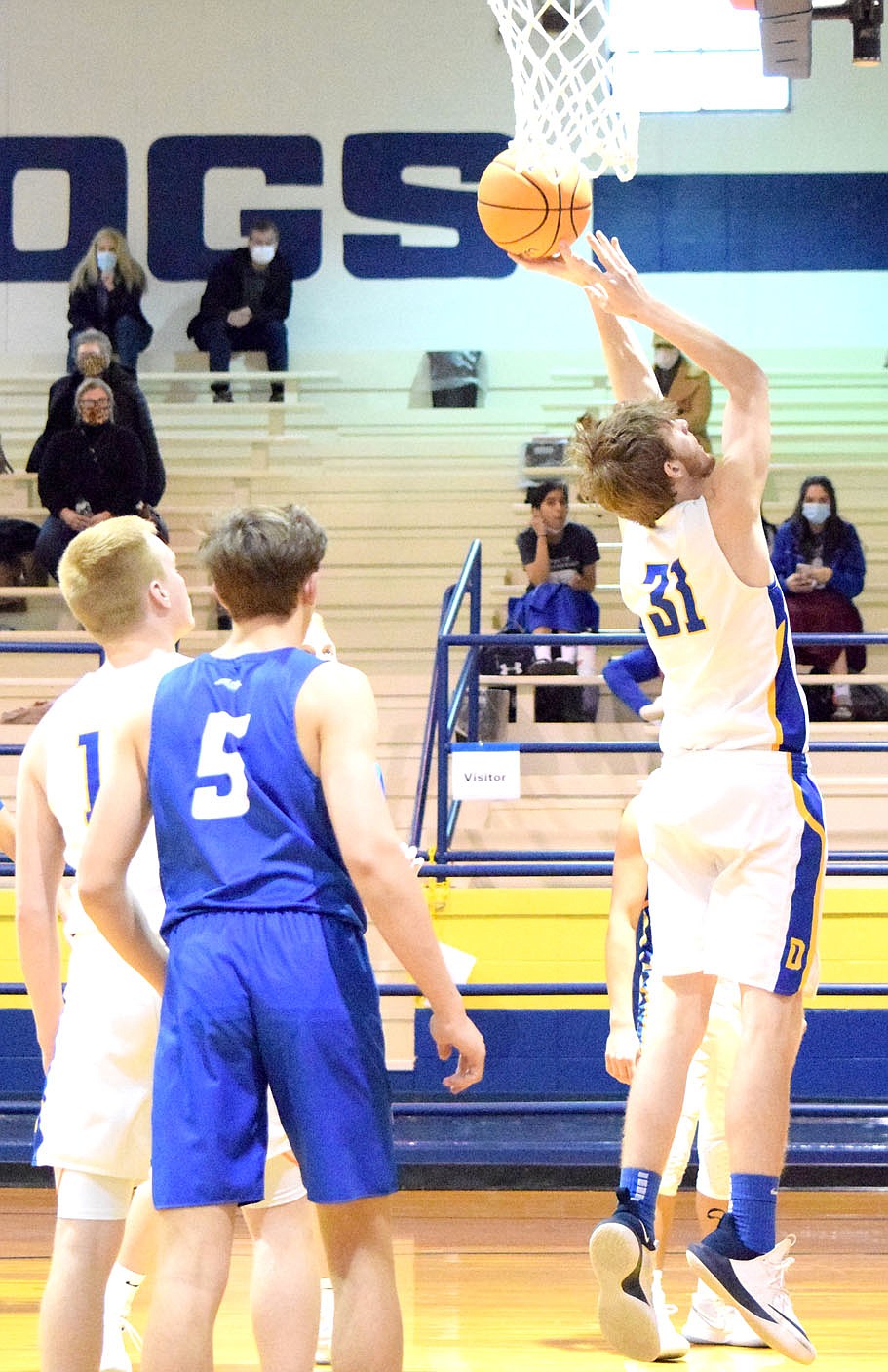 Westside Eagle Observer/MIKE ECKELS
Bulldog Trevor Girdnor (31) fights for a Griffin rebound during the second quarter of the Decatur-Ozark Catholic Academy varsity basketball contest at Peterson Gym Thursday afternoon. Girdnor was able to pull down the ball and dribble it away from the Griffin net and into Bulldog territory.