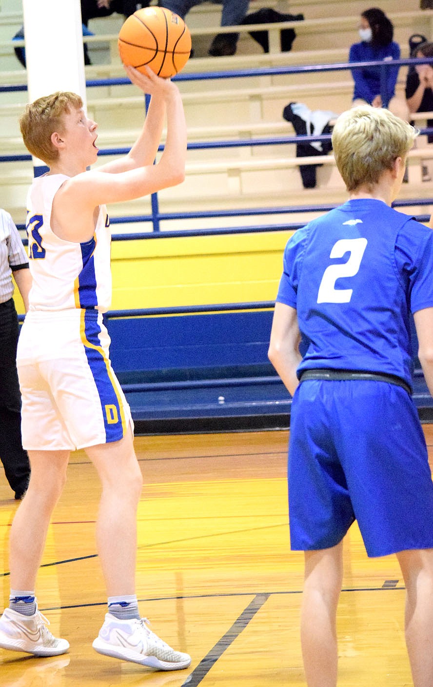 Westside Eagle Observer/MIKE ECKELS
Deegan Brooks puts up a free throw late in the third quarter of the Decatur-Ozark Catholic Academy basketball contest at Peterson Gym in Decatur Thursday afternoon. Brooks made the first free throw but missed his second attempt.