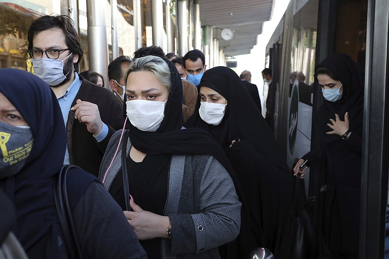 FILE - In this Oct. 11, 2020, file photo, people wear protective face masks to help prevent the spread of the coronavirus in downtown Tehran, Iran. Iranian media reported on Monday, Dec. 28 that an unidentified group of U.S.-based philanthropists plans to send 150,000 doses of the Pfizer vaccine to Iran in the coming weeks, in a step that could bring the hardest-hit country in the Middle East closer to inoculating its citizens against the coronavirus.  (AP Photo/Ebrahim Noroozi, File)