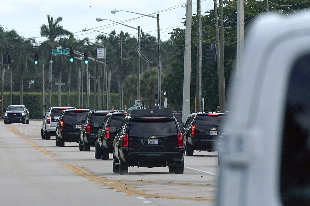 President Donald Trump's motorcade drives to Trump International Golf Club, Monday, Dec. 28, 2020, in West Palm Beach, Fla. (AP Photo/Patrick Semansky)