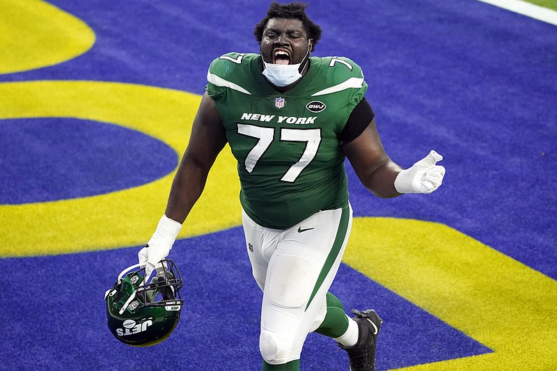 New York Jets offensive tackle Mekhi Becton (77) celebrates as he runs off the field after a win over the Los Angeles Rams during an NFL football game Sunday, Dec. 20, 2020, in Inglewood, Calif. (AP Photo/Ashley Landis)