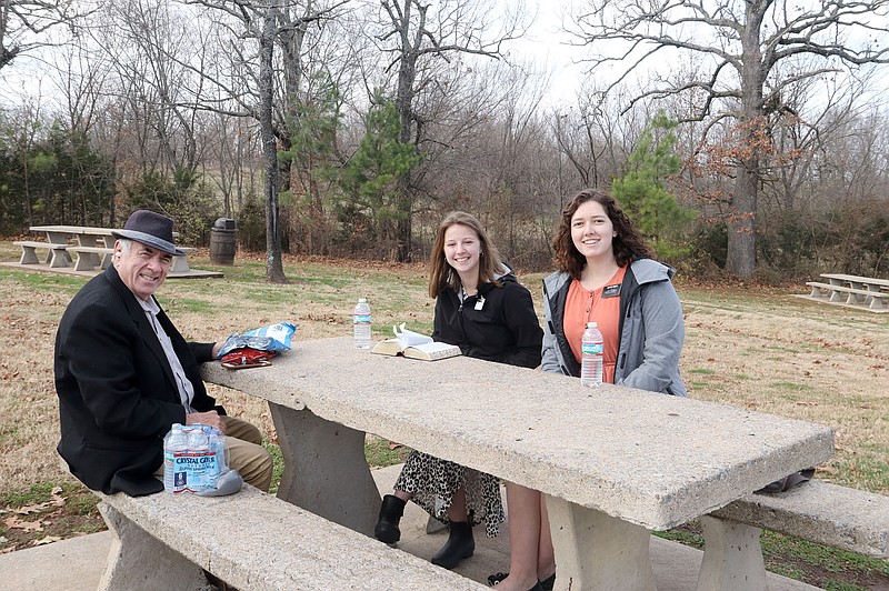 LYNN KUTTER ENTERPRISE-LEADER
Sister Shaelynn Hanson, left, and Sister Hannah Himes are enjoying their last few days in Prairie Grove before moving on to a new mission field with the Latter-day Saints of Jesus Christ. Above, they are visiting with Bill Bush of Lincoln at Prairie Grove Battlefield State Park. Hanson, who is from Idaho, has been in Prairie Grove for six months, and will move to Branson, Mo., for her next mission. Himes is from Utah and is just going down the highway to Fayetteville. She's only been in Prairie Grove for six weeks. Both are in college and took a break for an 18--month mission tour with the Latter-day Saints of Jesus Christ. They'll go back to college when they are finished. While in Prairie Grove, they have volunteered several places and helped residents with service projects and shared about the hope of Jesus Christ with many people. During the pandemic, they've had a lot of video calls and chats with people and posted videos to share with others. Himes said being a missionary during covid-19 has actually been the best time to be on the mission field because "help and hope is what people need right now."