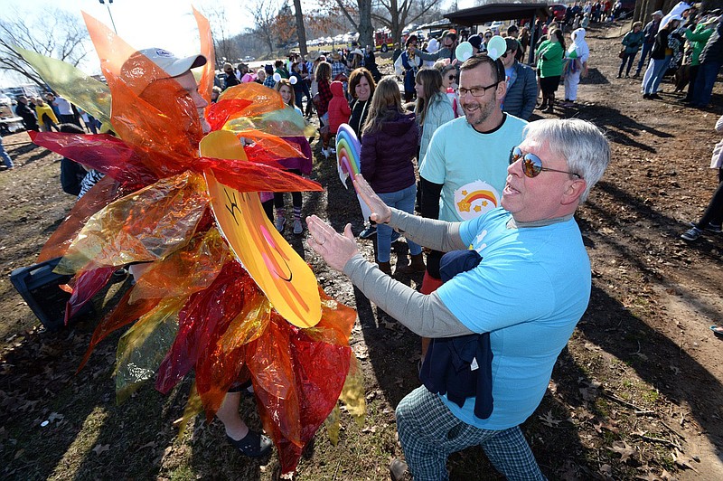 Drew Osborn (right) laughs Saturday, Feb. 8, 2020, as he warms his hands from John Schroeder's sun costume as he and other representatives from Elm Tree Elementary School in Bentonville prepare to take part in the 21st annual Beaver Lake Polar Plunge at Prairie Creek Swimming Area in Rogers. Teams and individuals dove into the 42-degree water to support Special Olympics Arkansas. Visit  nwaonline.com/200209Daily/ for today's photo gallery.
(NWA Democrat-Gazette/Andy Shupe)