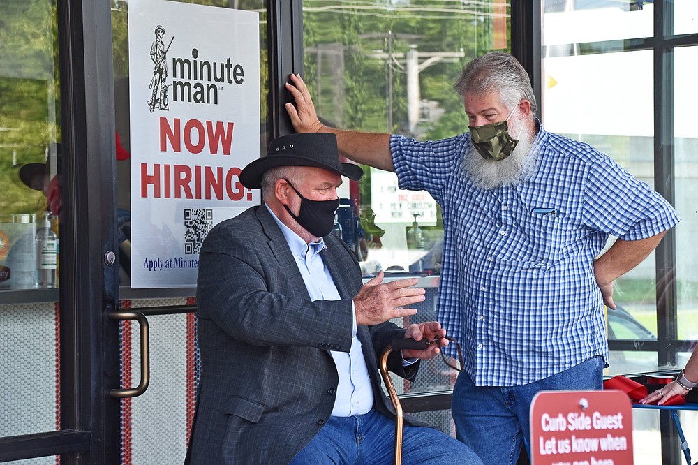 Jacksonville Mayor Bob Johnson (left) chatted with Jacksonvillian Jerry Saunders at the Minute Man grand opening. (Democrat-Gazette file photo/Staci Vandagriff)