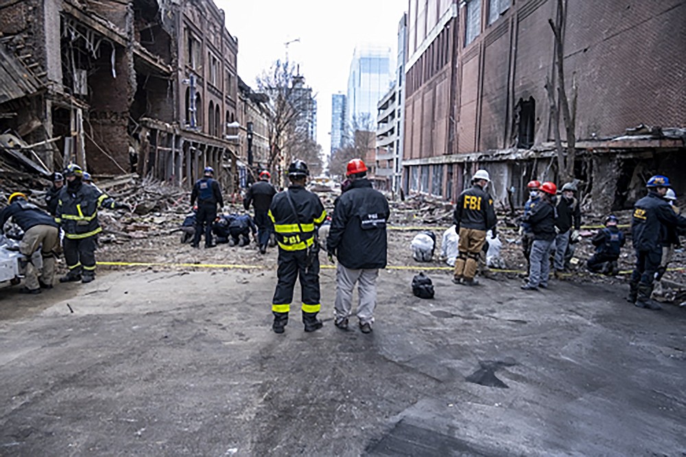In this photo provided by the FBI and Bureau of Alcohol, Tobacco, Firearms and Explosives, FBI and ATF Evidence Response Teams process the scene, Monday, Dec. 28, 2020, of the Christmas Day blast in Nashville, Tenn. The teams are searching for evidence to assist in the ongoing investigation. (FBI/ATF via AP)