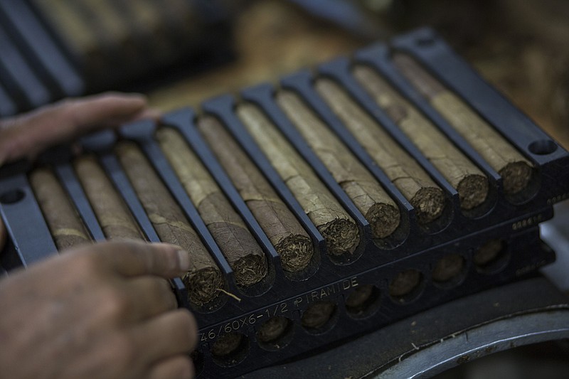 A worker packs cigars at the Quesada Cigars facility in Santiago de los Caballeros, Dominican Republic, on May 4, 2017. MUST CREDIT: Bloomberg photo by Dennis M. Rivera Pichardo