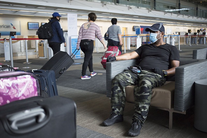 Soma Chire of Bentonville waits Aug. 29 for his family before heading off on a trip to India at Northwest Arkansas National Airport in Highfill. Monthly enplanement numbers from the airlines showed Northwest National down 62.4% last month compared to November 2019 when 76,199 people flew out of the airport. Go to nwaonline.com/210102Daily/ for today's photo gallery. 
(File Photo/NWA Democrat-Gazette/Charlie Kaijo)