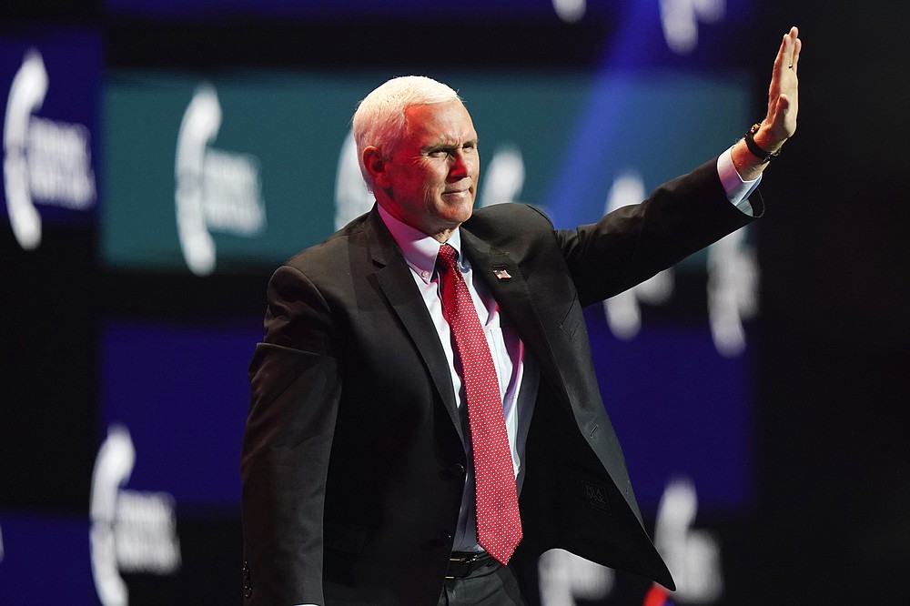 Vice President Mike Pence waves as he walks off the stage after speaking at the Turning Point USA Student Action Summit, Tuesday, Dec. 22, 2020, in West Palm Beach, Fla. (AP Photo/Lynne Sladky)