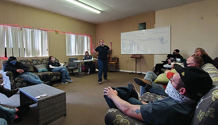 Marika Shields, women's director at Humbled Hearts in Harrison, tells a group from their sober living homes about her experience working each of the 12 steps. Shields graduated from the year-long program herself in 2019.  (Arkansas Democrat-Gazette/Ashton Eley)
