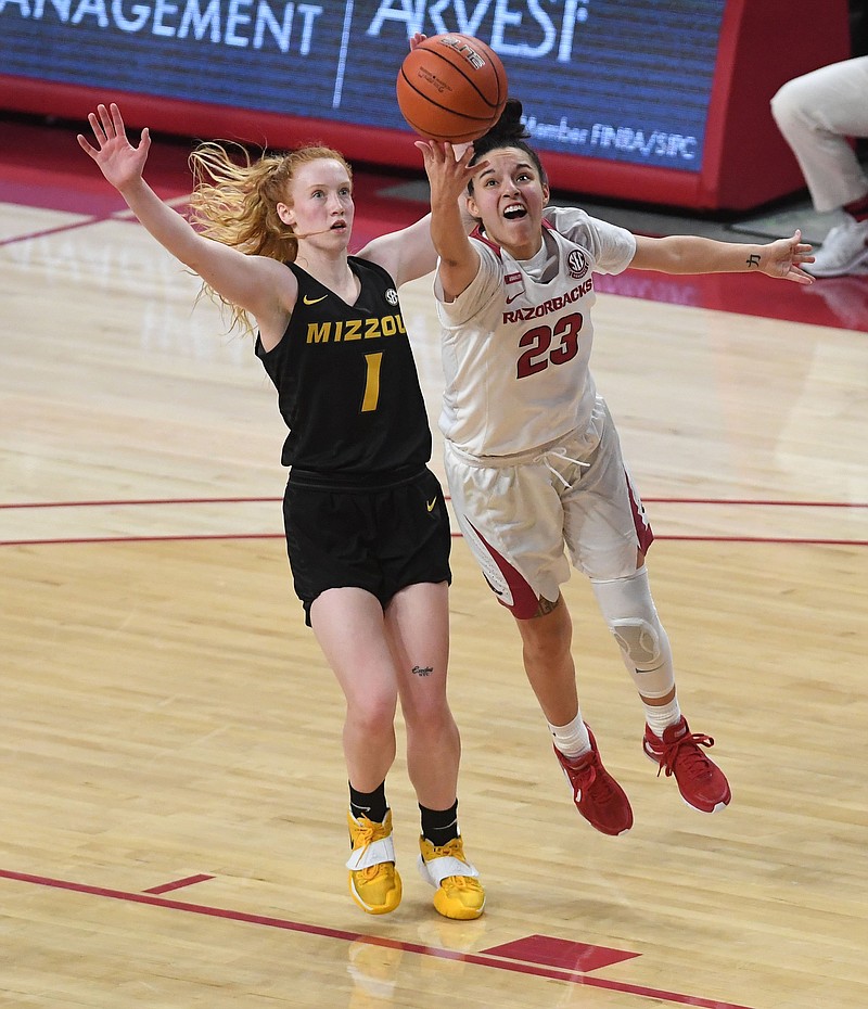 Arkansas’ Amber Ramirez shoots in front of Missouri’s Lauren Hansen Sunday at Bud Walton Arena in Fayetteville. Arkansas won 91-88. - Photo by J.T. Wampler of NWA Democrat-Gazette