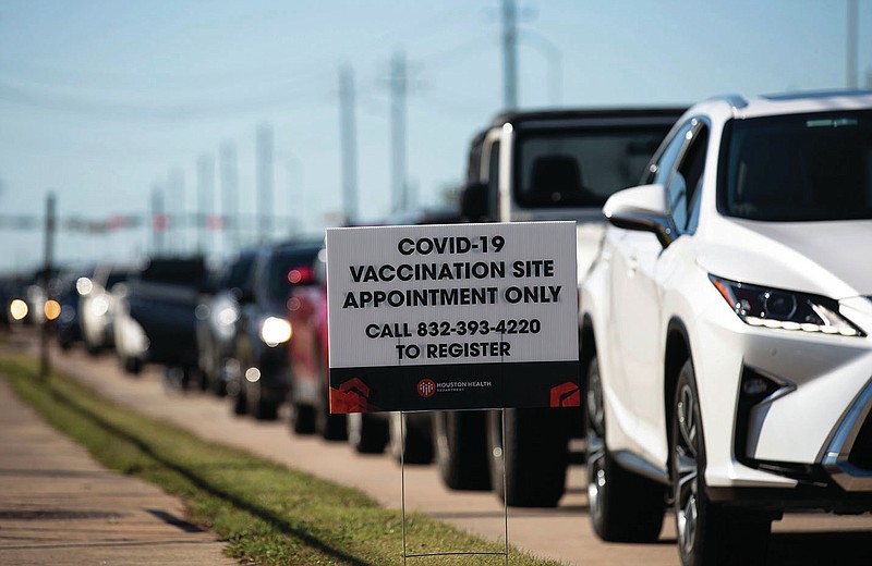 People who qualify under Phase 1A or Phase 1B of the state's guidelines wait for their turn to receive the COVID-19 vaccine Sunday, Jan. 3, 2021, at a Houston Health Department's COVID-19 vaccine clinic in Houston. The department vaccinated 1,008 people who qualify under Phase 1A or Phase 1B of the state's guidelines at the clinic's first day on Saturday. (Yi-Chin Lee/Houston Chronicle via AP)