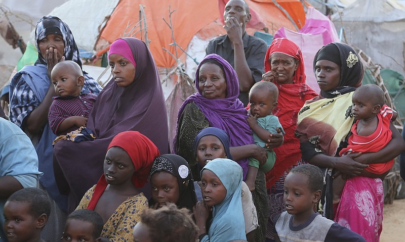 Internally displaced people gather in Daynile camp in Mogadishu, Somalia on Thursday Dec. 17, 2020. As richer countries race to distribute COVID-19 vaccines, Somalia remains the rare place where much of the population hasn't taken the coronavirus seriously. Some fear that’s proven to be deadlier than anyone knows. (AP Photo/Farah Abdi Warsameh)