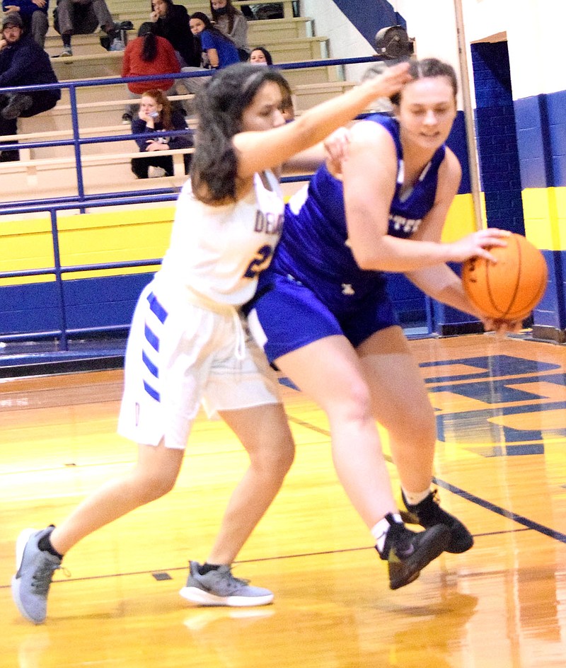 Westside Eagle Observer/MIKE ECKELS
Jazman Herrera (22 left) tries to force Hailey Cunningham (20, right) into a trap along the sideline during the second quarter of the Decatur-Cotter varsity girls game in Decatur Friday night. Herrera forced Cunningham to lose control of the ball and go out of bounds with the possession going to the Lady Bulldogs,