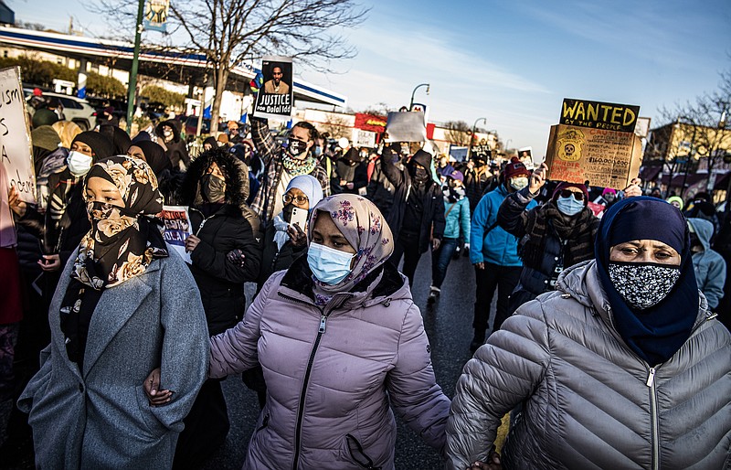 Protesters rally against police brutality, Sunday, Jan. 3, 2021, in Minneapolis, at the gas station where Dolal Idd was shot by Minneapolis police several days earlier. (Richard Tsong-Taatarii/Star Tribune via AP)